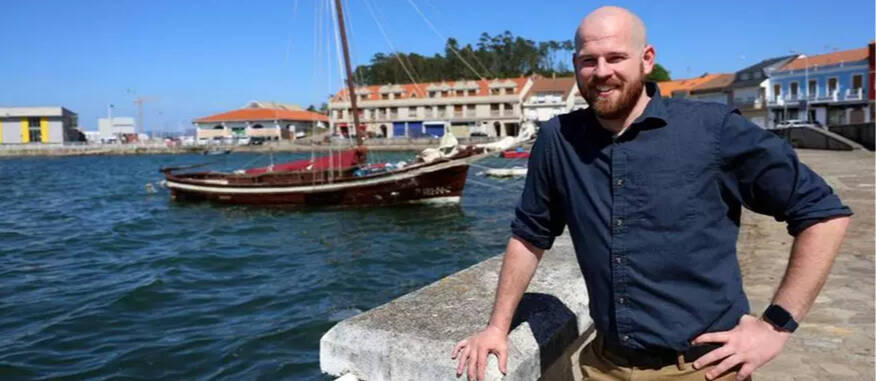 Alumni Eliot Westdorp, right, adjacent to a marina, left